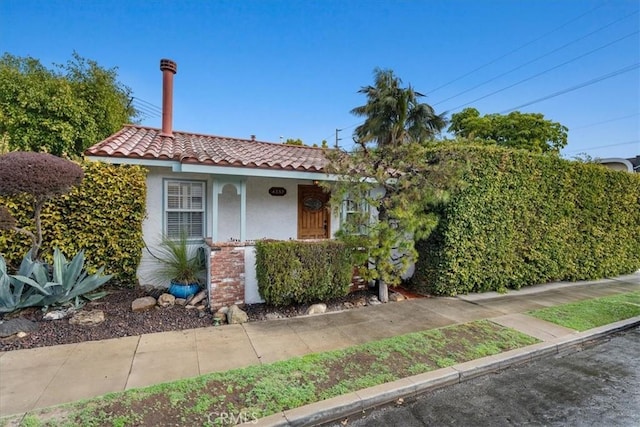 view of front of property with a tile roof and stucco siding