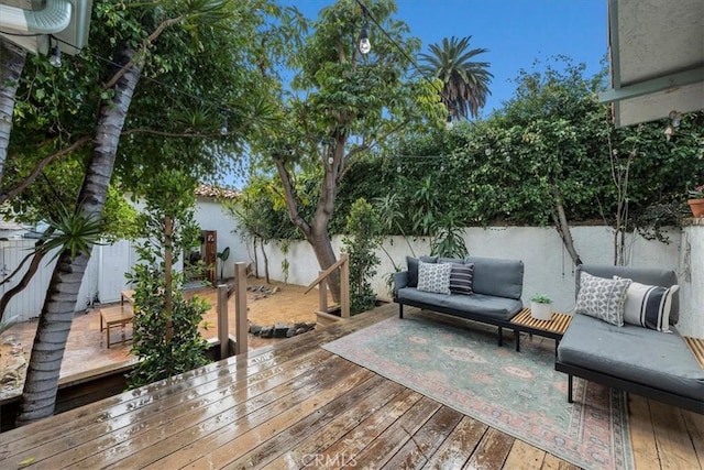 wooden deck with a fenced backyard