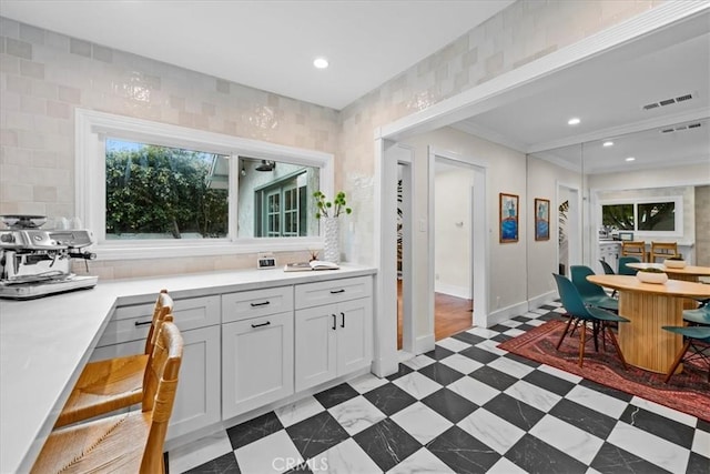 interior space with recessed lighting, dark floors, visible vents, and ornamental molding