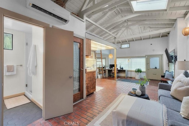 living area featuring beam ceiling, high vaulted ceiling, an AC wall unit, brick floor, and baseboards