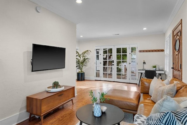 living room featuring recessed lighting, french doors, wood finished floors, and crown molding