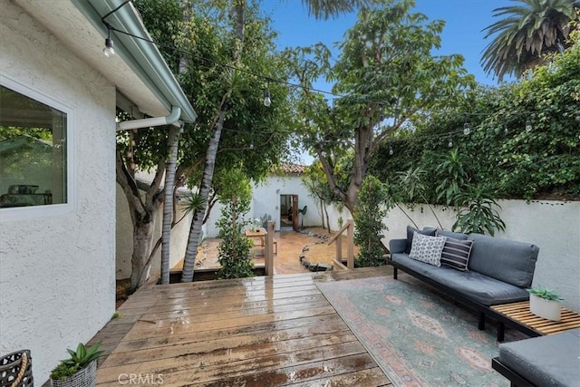 view of patio with an outdoor hangout area, a deck, and fence