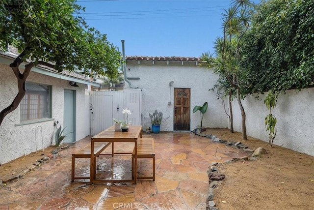 view of patio with outdoor dining area and fence