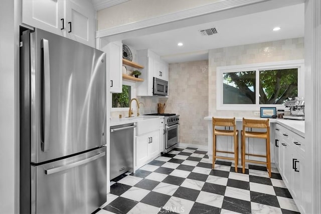 kitchen with visible vents, open shelves, appliances with stainless steel finishes, dark floors, and light countertops