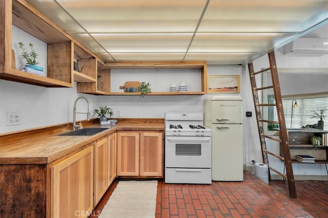 kitchen featuring a sink, butcher block counters, brick floor, white appliances, and open shelves