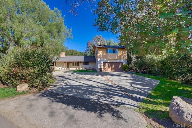 tri-level home featuring driveway and a garage