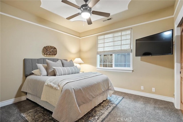 carpeted bedroom with visible vents, baseboards, and ceiling fan