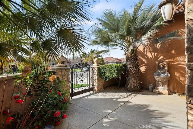 view of patio featuring a gate