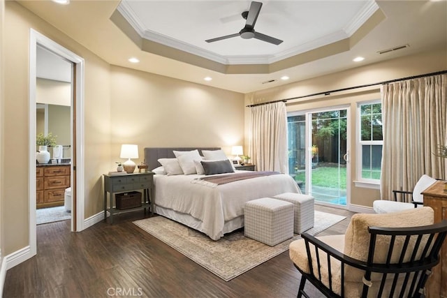 bedroom featuring a tray ceiling, access to outside, visible vents, and dark wood-type flooring