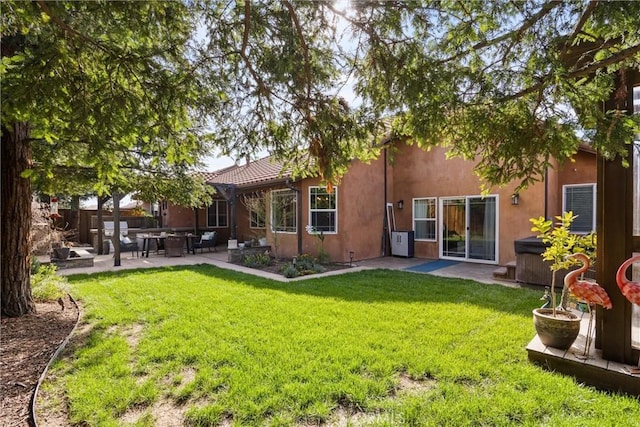 back of house with a lawn, fence, a patio, and stucco siding