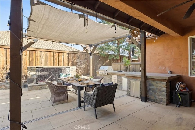 view of patio featuring area for grilling, outdoor dining area, and fence