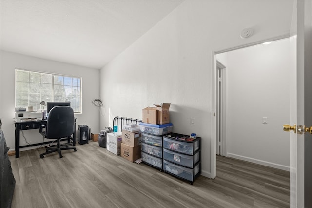 office with lofted ceiling, wood finished floors, and baseboards