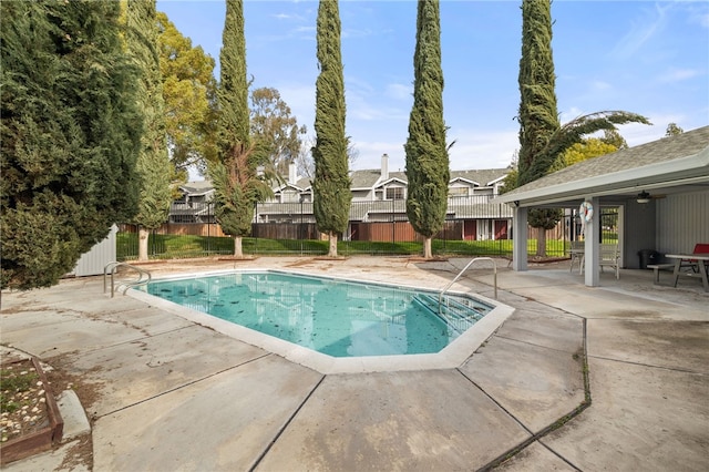 view of pool with a fenced in pool, fence, and a patio area