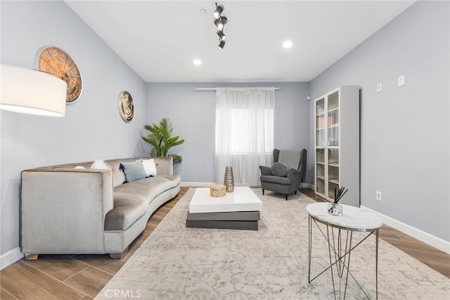 living area featuring recessed lighting, baseboards, and wood finished floors