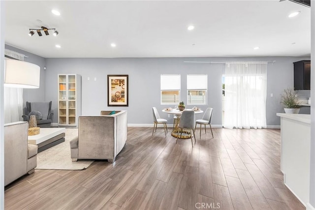 living room with recessed lighting, wood finished floors, and baseboards