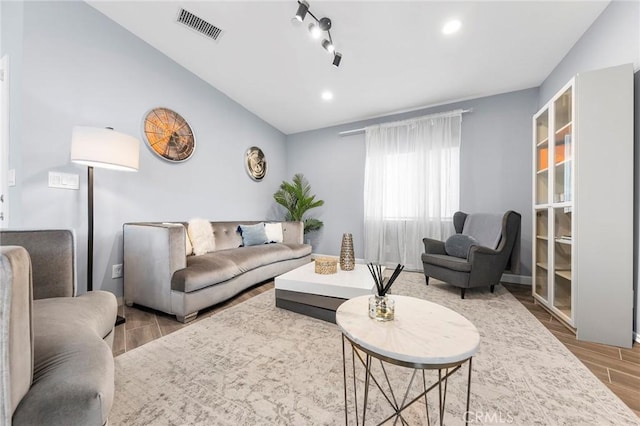 living area featuring vaulted ceiling, recessed lighting, wood finished floors, and visible vents