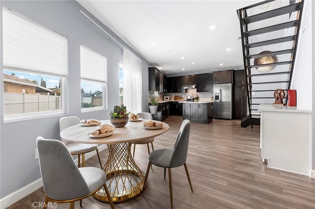 dining space with a wealth of natural light, baseboards, wood finished floors, and recessed lighting