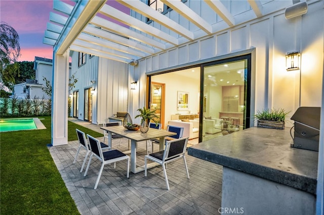 patio terrace at dusk with a yard, outdoor dining space, and a pergola