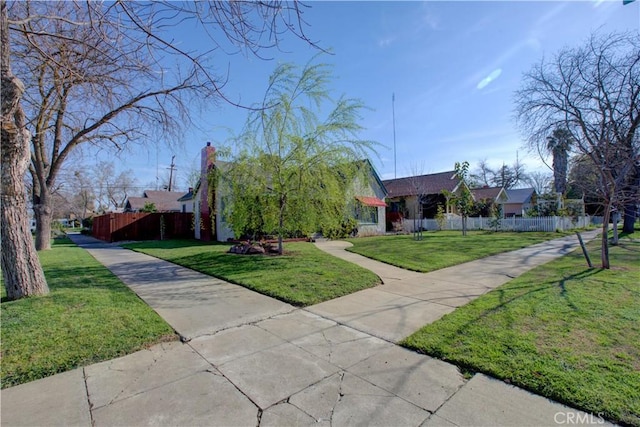 view of front of home featuring a front yard and fence