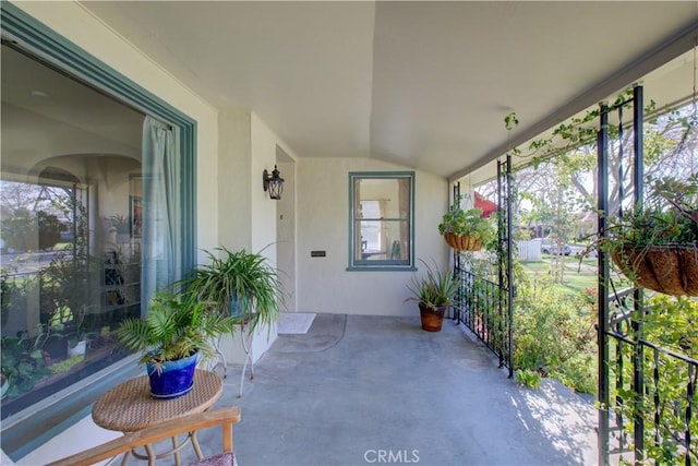 unfurnished sunroom with lofted ceiling