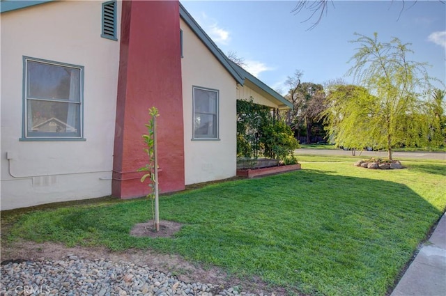 view of side of home with crawl space, a lawn, and stucco siding