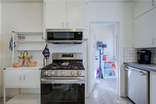 kitchen featuring decorative backsplash, appliances with stainless steel finishes, light countertops, and white cabinetry