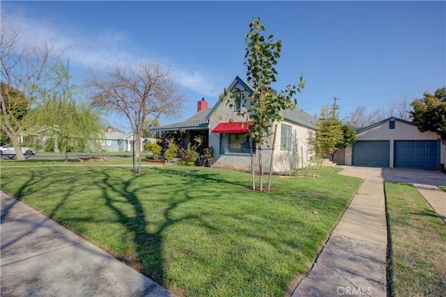 view of front of house with a chimney, a garage, a front lawn, and an outdoor structure