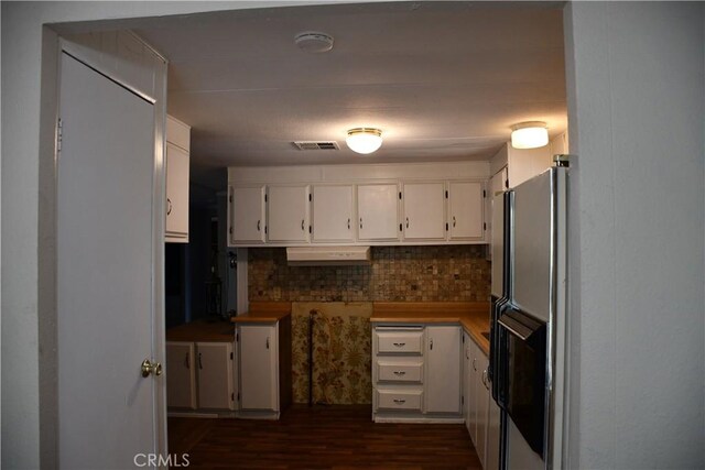 kitchen with dark wood-style floors, visible vents, white cabinetry, and fridge with ice dispenser