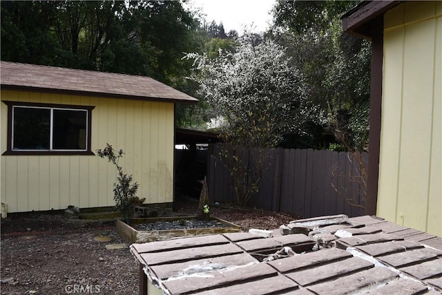 exterior space featuring a garden and fence