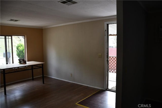 interior space with visible vents, baseboards, wood finished floors, and crown molding