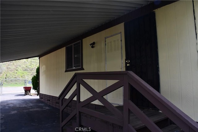 doorway to property featuring an attached carport