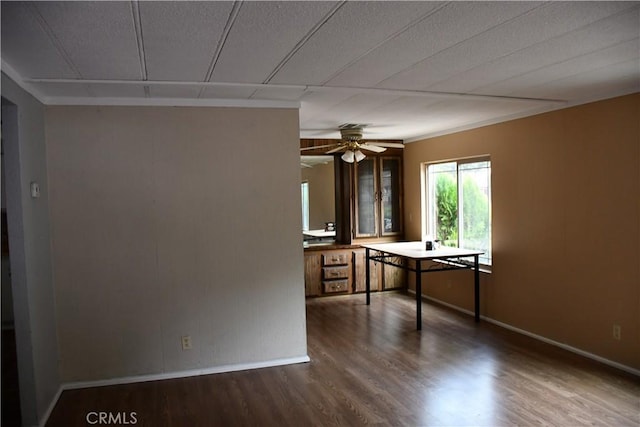 unfurnished room featuring baseboards, a textured ceiling, wood finished floors, and a ceiling fan