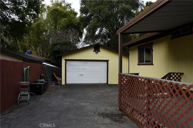 detached garage with driveway and fence