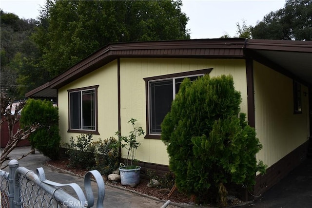 view of side of property featuring fence