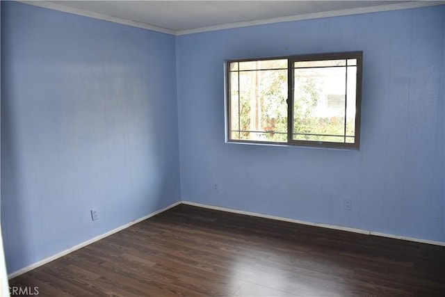 unfurnished room featuring crown molding, baseboards, and dark wood-style flooring