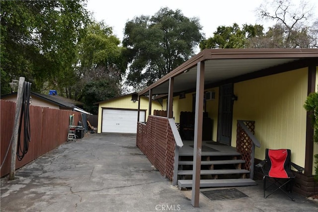 exterior space featuring a garage and fence