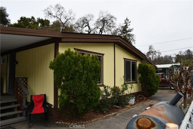 view of side of home with a patio