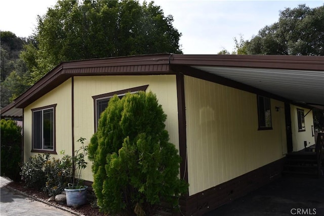 view of side of property featuring a carport