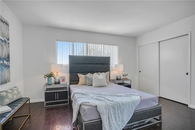 bedroom featuring wood finished floors, a closet, and baseboards