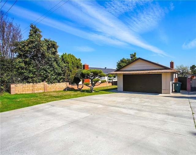 garage with driveway and fence