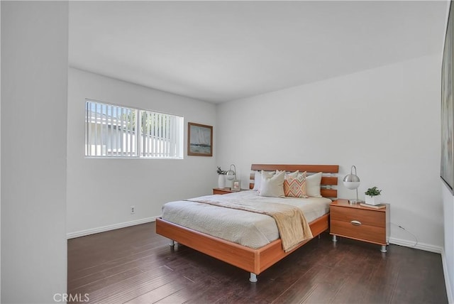 bedroom featuring hardwood / wood-style floors and baseboards