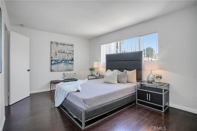 bedroom featuring baseboards and wood finished floors