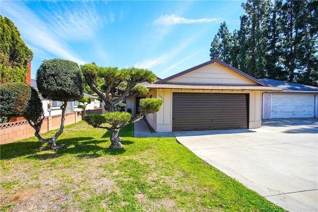 ranch-style house with a front lawn, a garage, and driveway