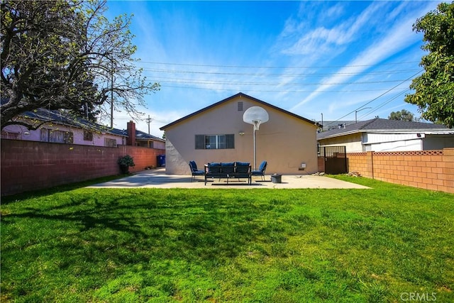 back of house with a patio, a yard, a fenced backyard, and stucco siding