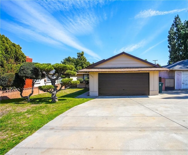 ranch-style home with a garage, concrete driveway, and a front yard