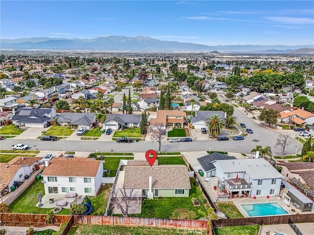 drone / aerial view featuring a residential view and a mountain view