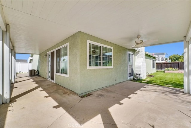 view of patio featuring cooling unit, fence, and ceiling fan