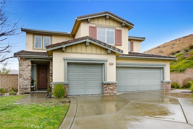 craftsman house with stone siding, driveway, a garage, and fence