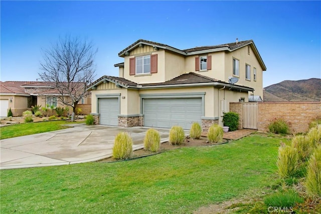 view of front of home with concrete driveway, an attached garage, a front yard, and stone siding