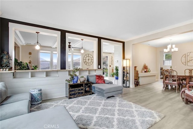 living area featuring a chandelier and wood finished floors